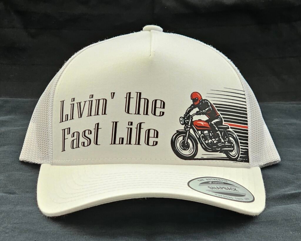 White mesh snapback hat with “Livin’ the Fast Life” text and vintage motorcycle graphic on the front panel