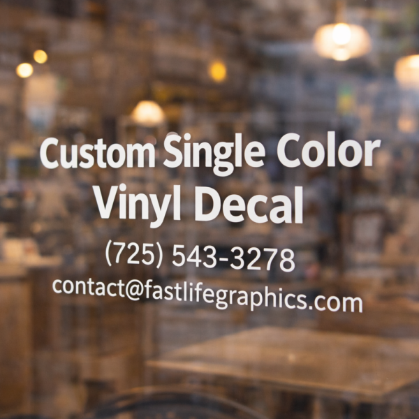 Custom single-color vinyl decal applied to a storefront window with business contact information