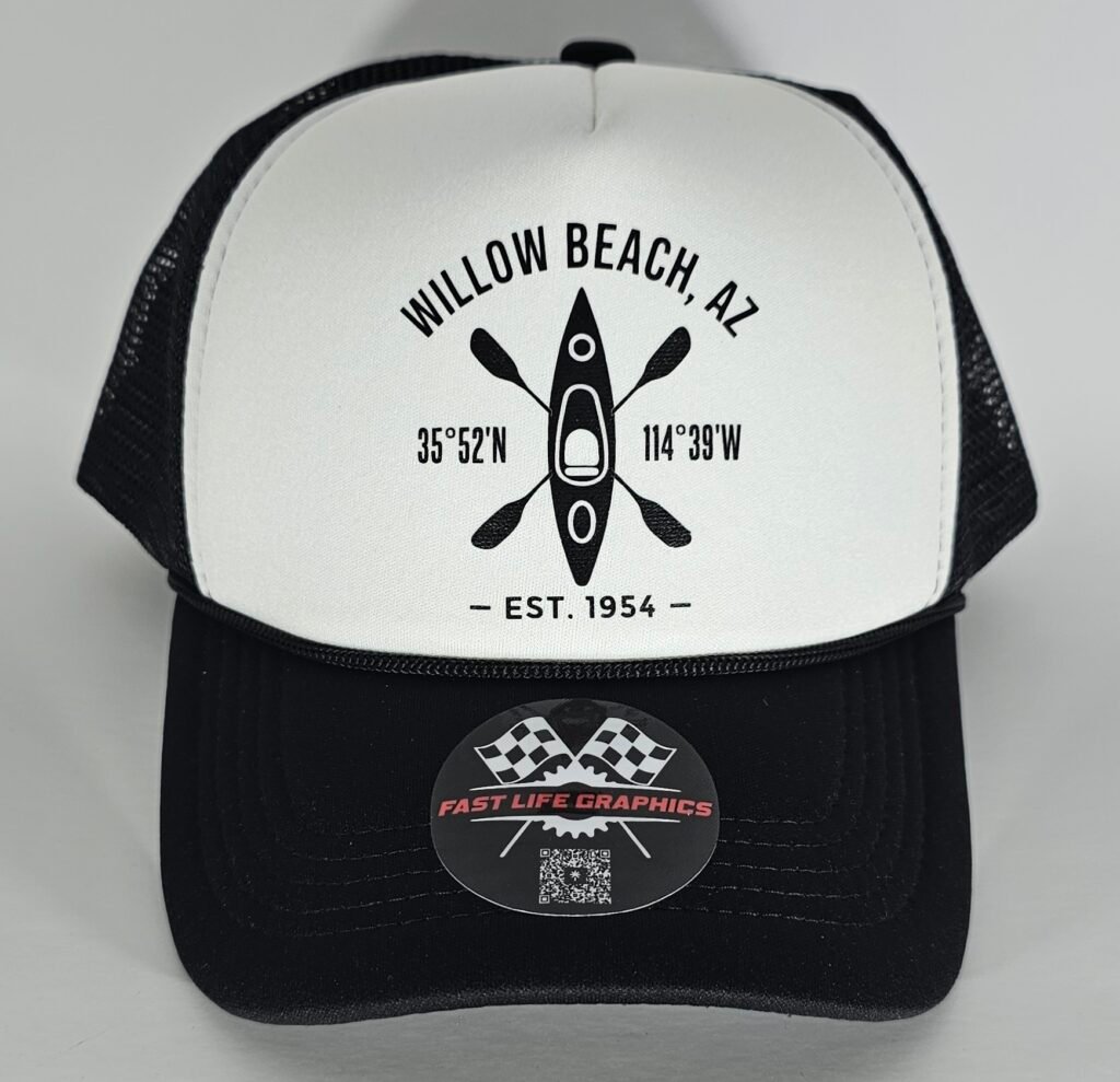 White foam front and black mesh trucker hat featuring a minimalist black kayak and crossed paddle design with Willow Beach, AZ coordinates and establishment year printed on the front panel.