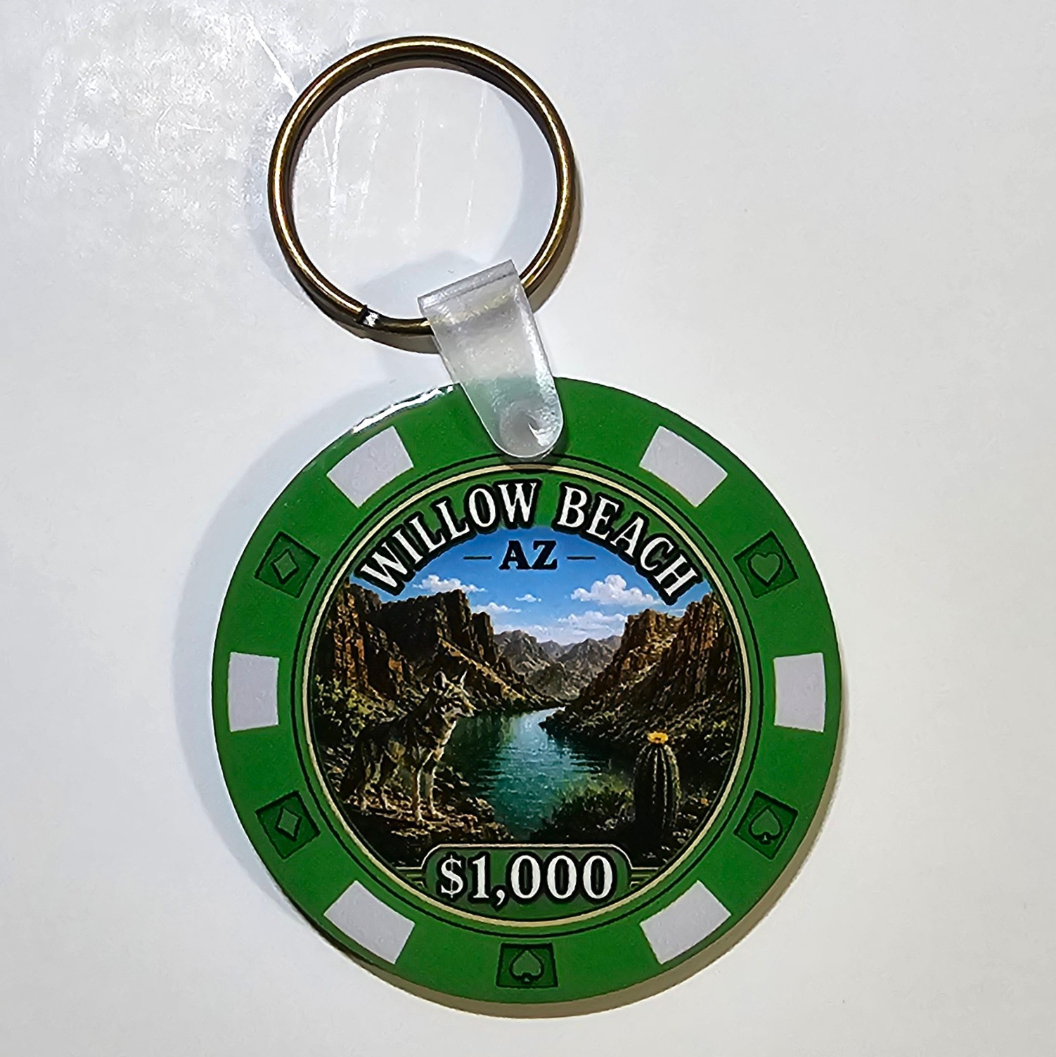 Emerald green Willow Beach Arizona poker chip keychain featuring a Black Canyon river scene with a coyote, barrel cactus, and attached metal key ring.