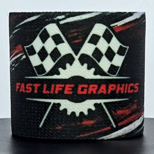 Black motorcycle brake reservoir cover with red Fast Life Graphics lettering, crossed checkered flags, and white/red racing-stripe details.