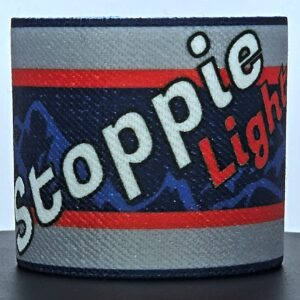 Gray, red, and blue Stoppie Light motorcycle brake reservoir cover with mountain graphics.